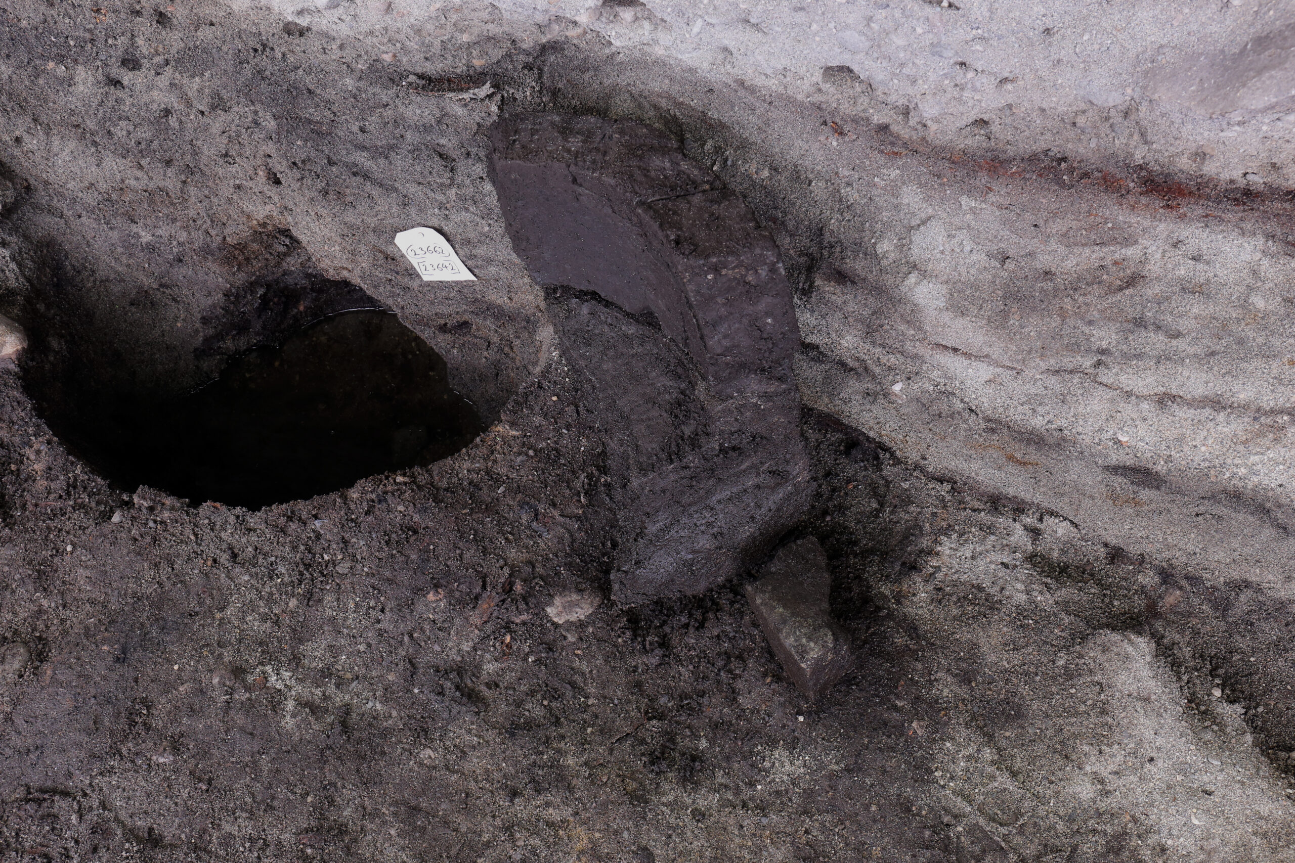 While excavating the wooden posts, several pieces of a finely-carved soapstone font were found